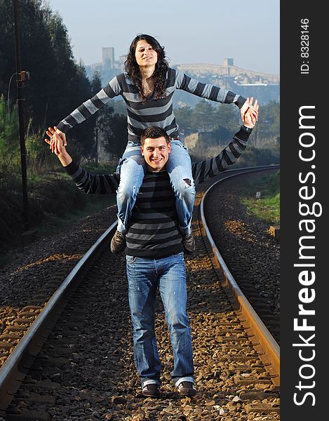 Young couple walking on railway tracks