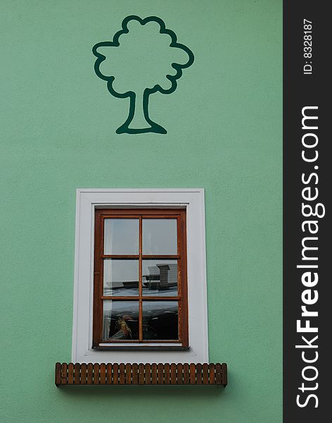 Window with tree painted on the green wall. Window with tree painted on the green wall