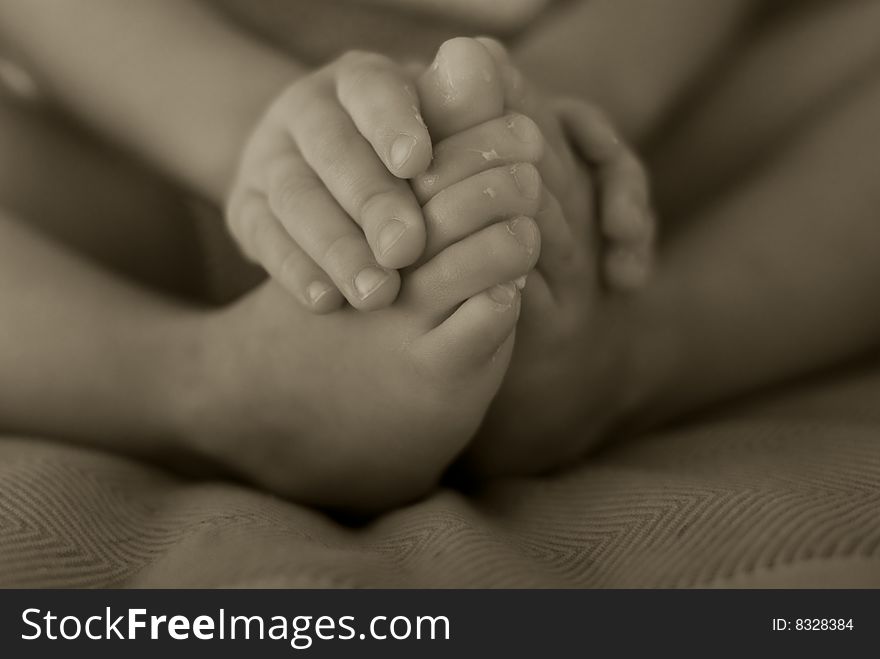 Black and white shot of a baby and his fingers and toes. Black and white shot of a baby and his fingers and toes.