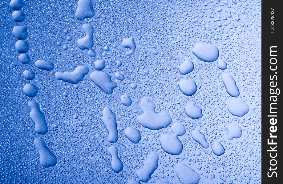 Mineral water drops on blue light background