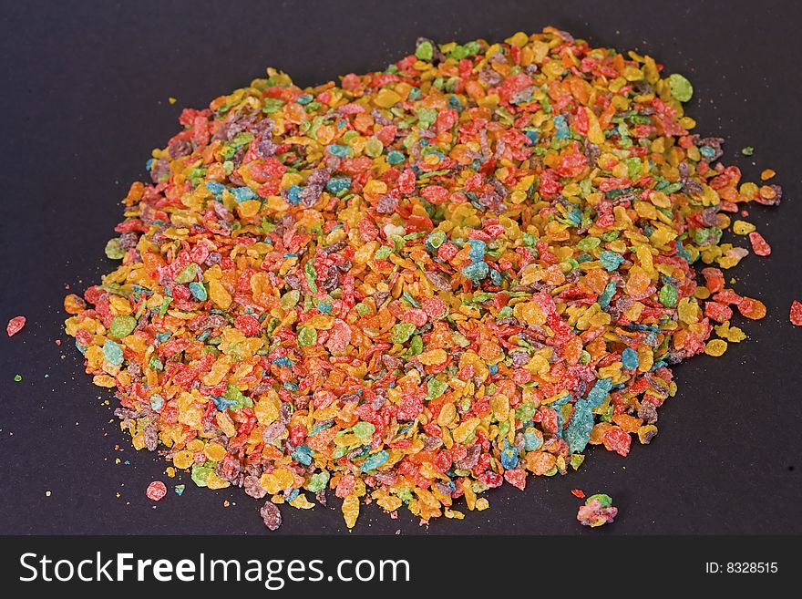 Bright colors and great textures are featured on this photograph of cereal on a black background. Bright colors and great textures are featured on this photograph of cereal on a black background