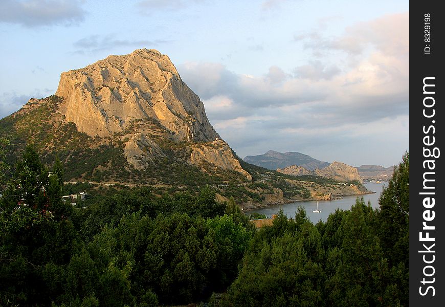 Mountainous landscape in the evening. Mountainous coast. Mountainous landscape in the evening. Mountainous coast.