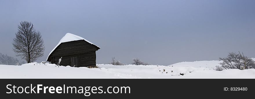 Winter landscape;Lonley house in a village in the mountains,in Romania. Winter landscape;Lonley house in a village in the mountains,in Romania