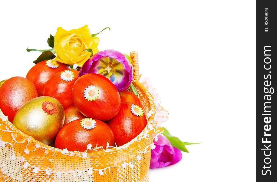 Easter basket with red and golden eggs over white