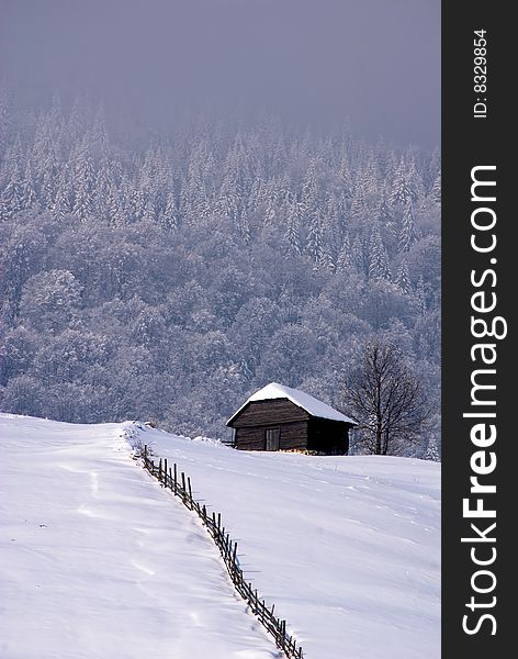 Winter landscape;Lonley house in a village in the mountains,in Romania. Winter landscape;Lonley house in a village in the mountains,in Romania