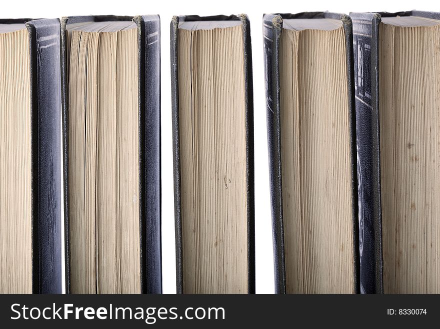 Antique leather-bound books arranged in a row, back-lit against white. Old and used encyclopaedia. Antique leather-bound books arranged in a row, back-lit against white. Old and used encyclopaedia.