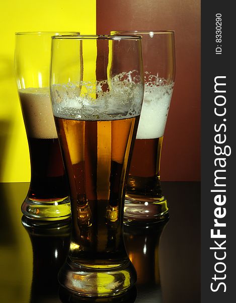 Three glasses with light and dark beer