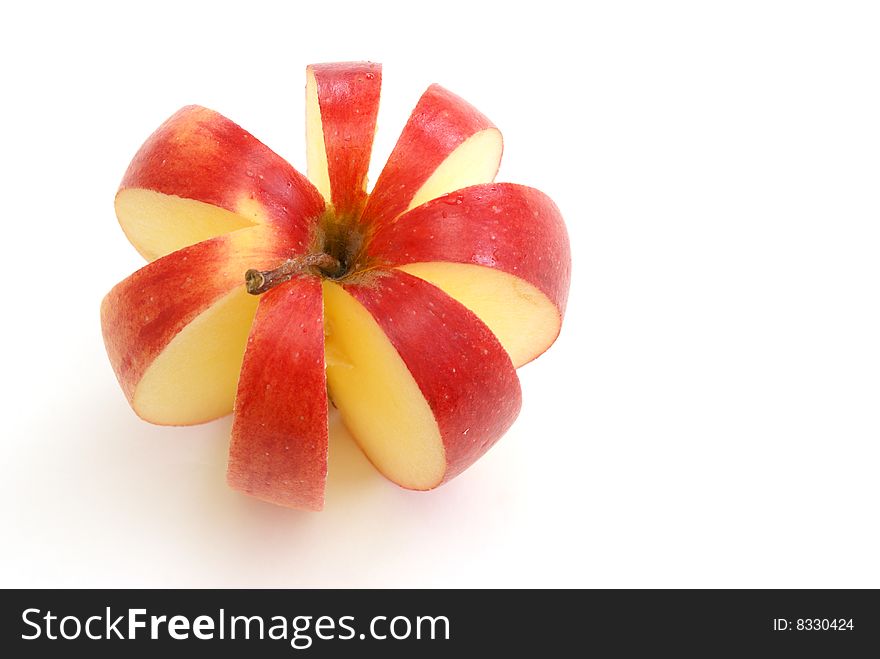 An apple is sliced to make a flower shape. An apple is sliced to make a flower shape.