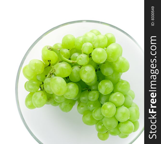 Green grapes in bowl on white background