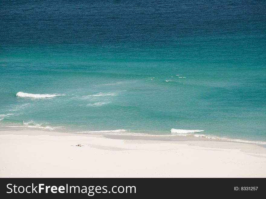 Two people lying on very remote beach. Two people lying on very remote beach