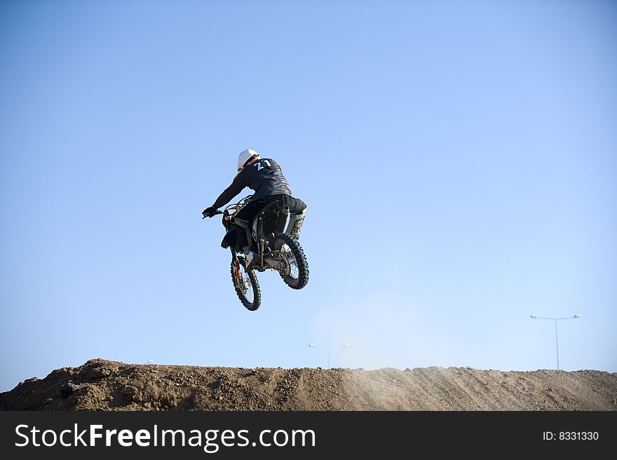 Motocross racer riding motorcycle outdoor