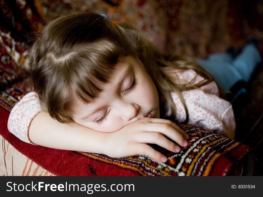 Stock photo: an image of a pretty little girl sleeping on a sofa. Stock photo: an image of a pretty little girl sleeping on a sofa