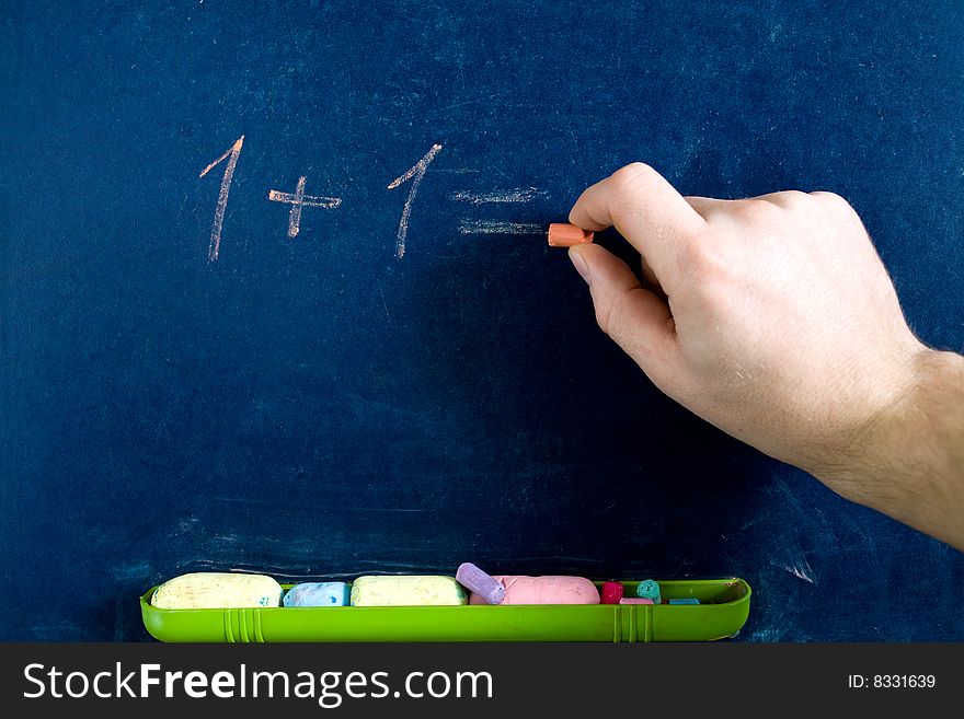 Stock photo: an image of a hand writing numbers on blackboard. Stock photo: an image of a hand writing numbers on blackboard