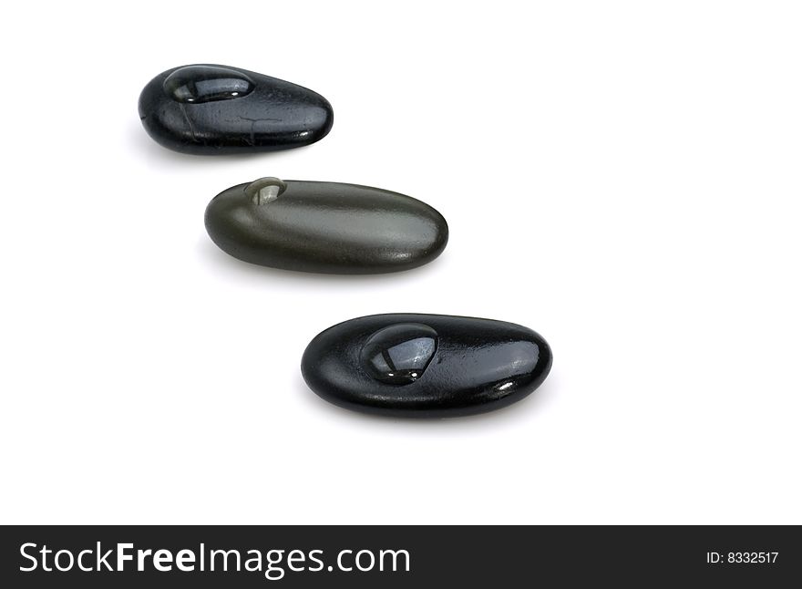 Dark pebble stones with water drops