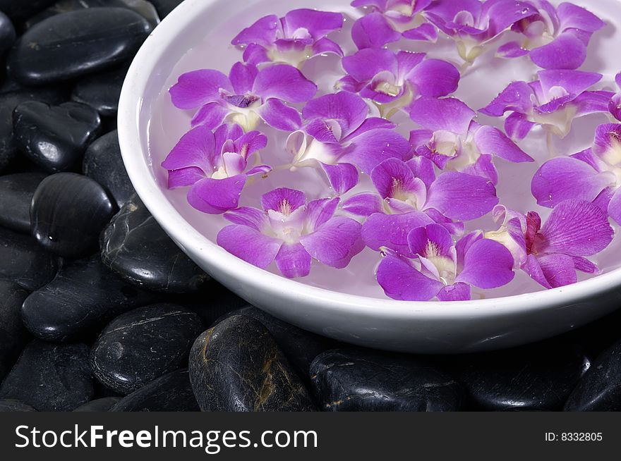 Floral scented water and black pebbles. Floral scented water and black pebbles