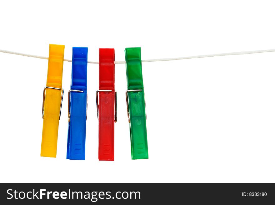 Four many-coloured clothespins hanging on the clothesline isolated on white background. Composition with copy space.