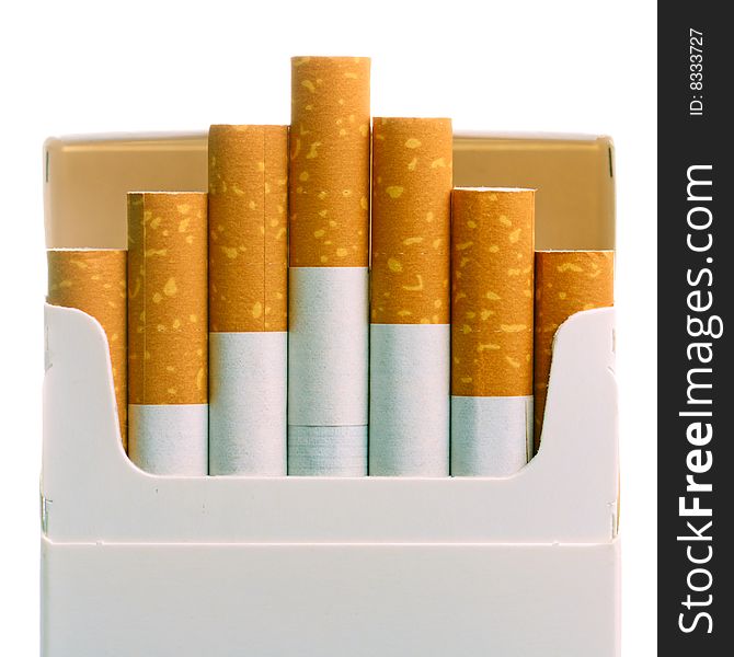 Pack of cigarettes with cigarettes sticking out isolated on white.