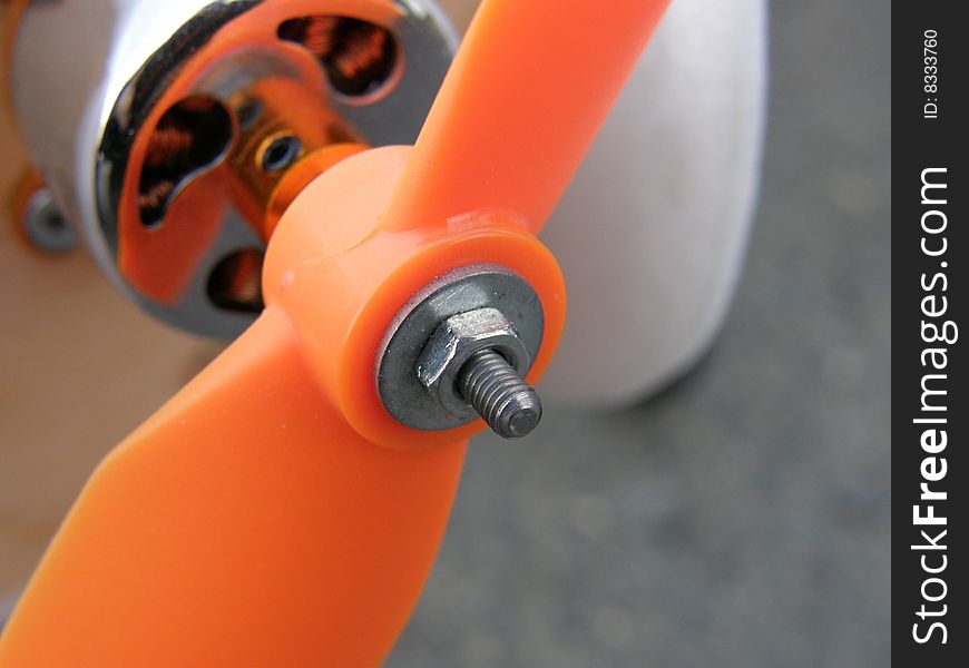 Orange plastic propeler on AC model engine. Orange plastic propeler on AC model engine