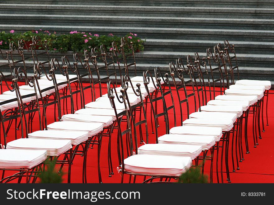 Many chairs on a red carper