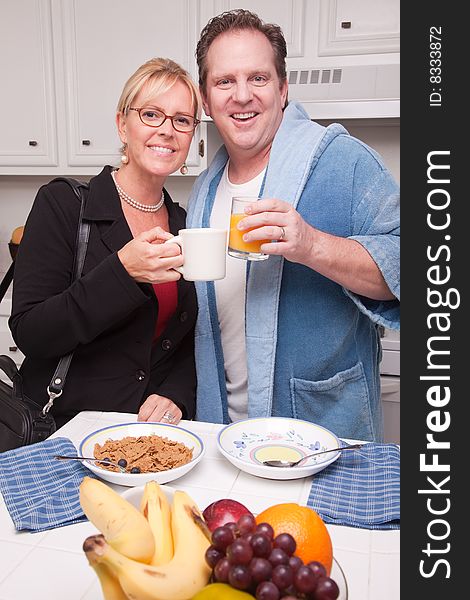 Businesswoman With Husband In Kitchen