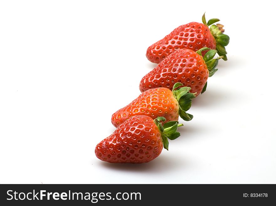 Line of  strawberries on a white background. Line of  strawberries on a white background