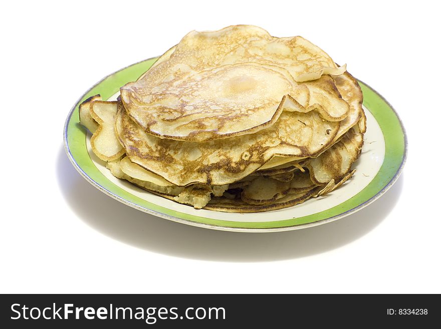 Pancakes at the plate on a white background