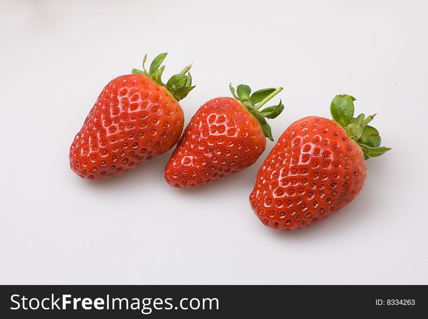 Trio of  strawberries on a white background. Trio of  strawberries on a white background