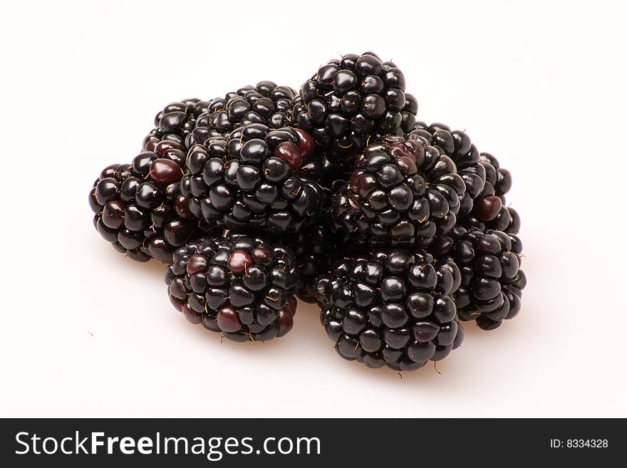 A group of blackberries on a white background