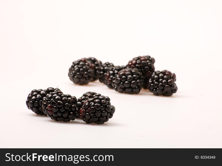 A group of blackberries on a white background