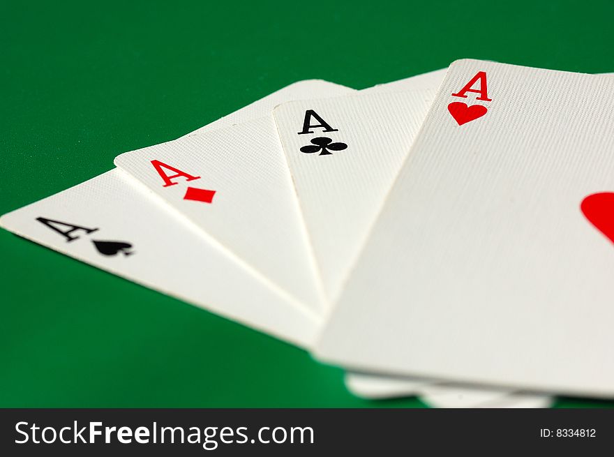 Four aces on green background