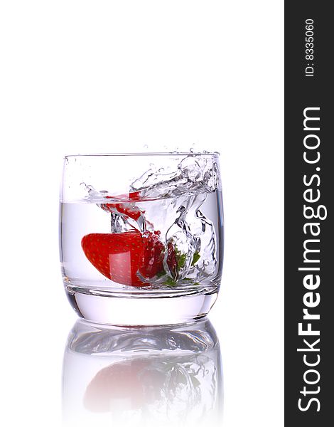Water glass with strawberry and splash