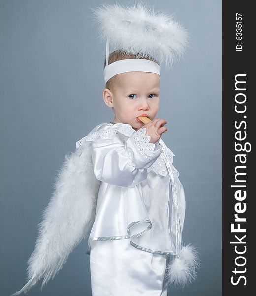 Baby angel girl with nimbus and fluffy wings