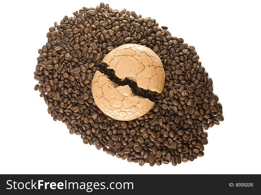 The broken macaroon on the coffee grain. The broken macaroon on the coffee grain