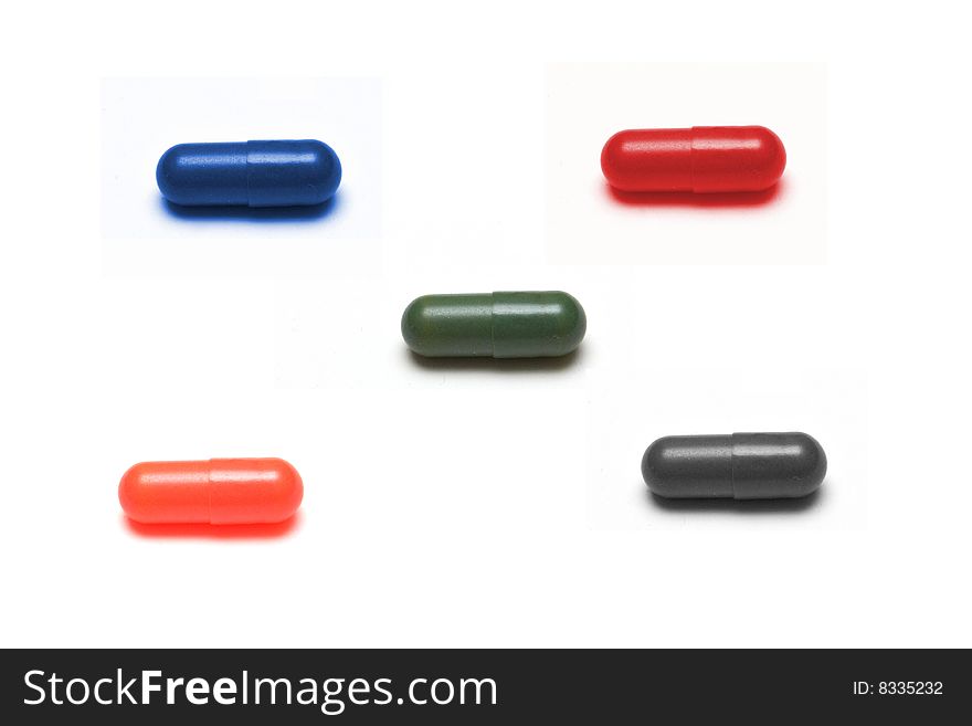 5 Differently colored capsules isolated on a white background. 5 Differently colored capsules isolated on a white background.