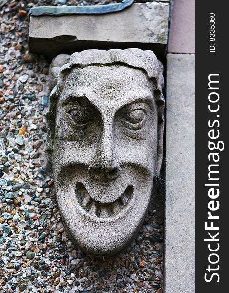 Ugly gargoyles head made from carved stone