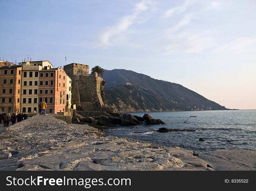 The typical coloured houses of Camogli and Portofino mountain on background. The typical coloured houses of Camogli and Portofino mountain on background