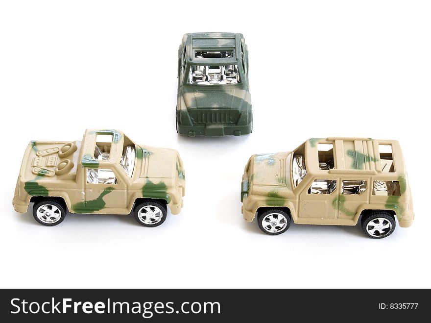 Three toy military vehicles on white background.