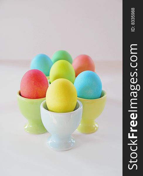 Easter eggs in pastel egg cups