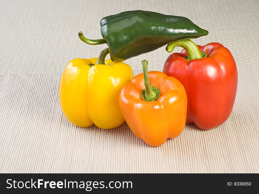 Colorful stacked peppers on a table with copy space