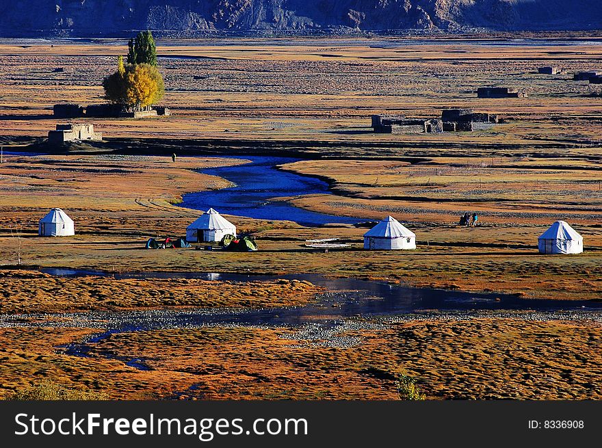 Meadows and brook with tents in South Singkiang,China. Meadows and brook with tents in South Singkiang,China