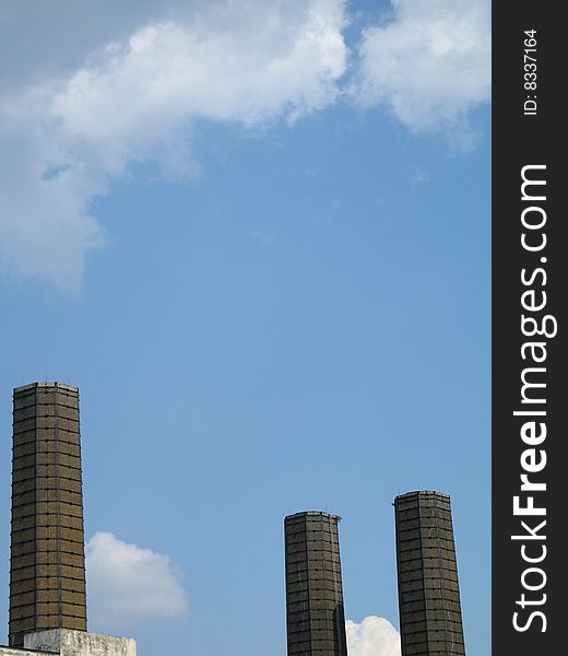 Industrial chimneys against the blue sky