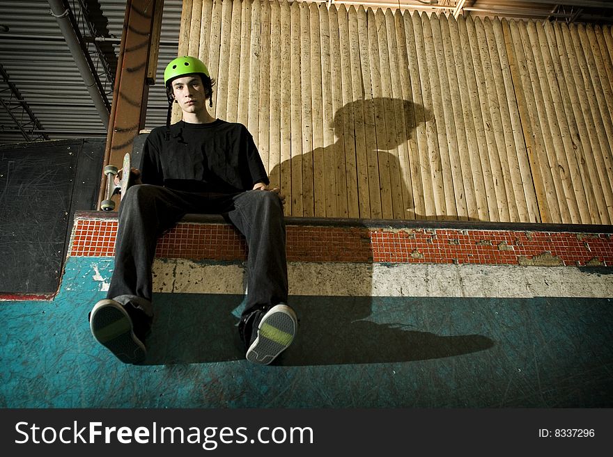 Skateboarder Sitting On Ramp