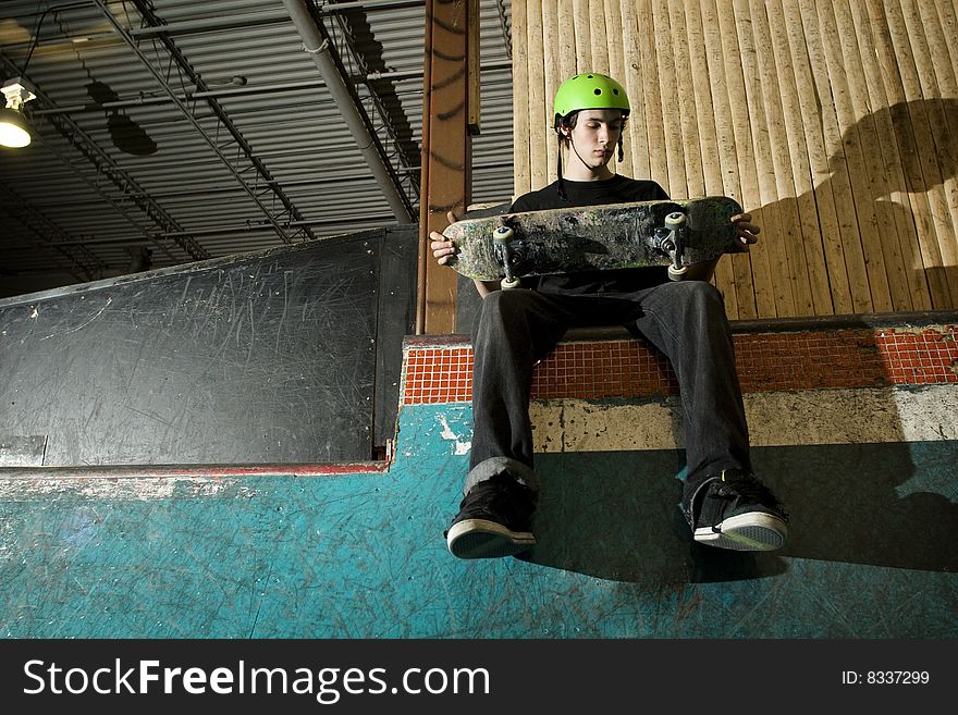 Skateboarder Checking His Board