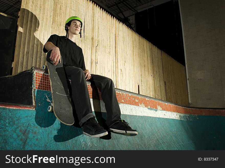 Skateboarder Sitting On Ramp