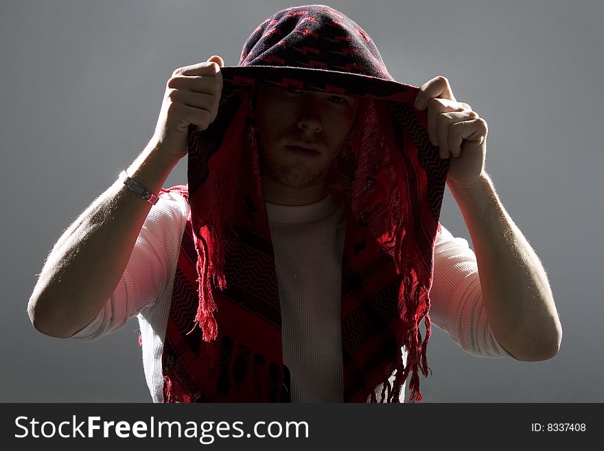 Backlit Man Hiding Face With Scarf