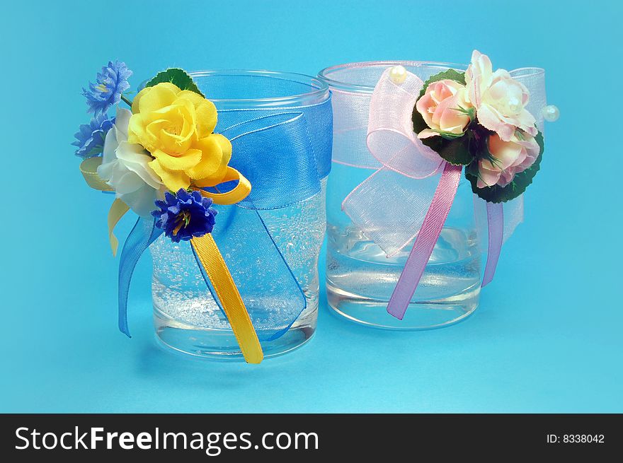 Glasses with flowers isolated on blue