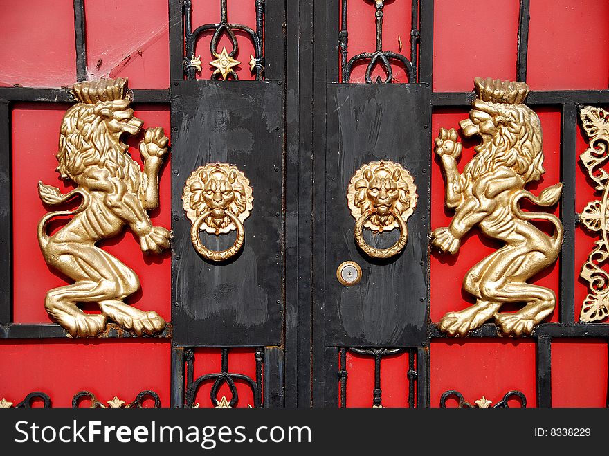 Double brass lions and lion face door knockers adorn the entrance gate to a farmhouse courtyard in Pengzhou, Sichuan Province, China - Lee Snider Photo. Double brass lions and lion face door knockers adorn the entrance gate to a farmhouse courtyard in Pengzhou, Sichuan Province, China - Lee Snider Photo.