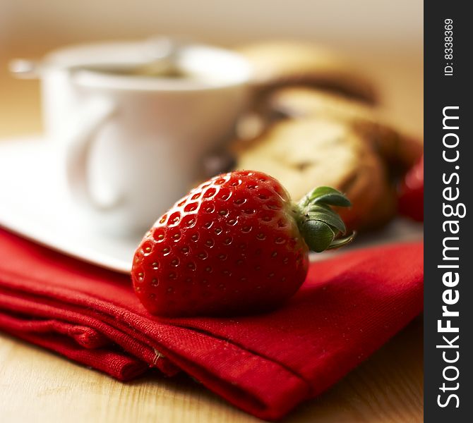 Strawberry with coffee and cookies in the background. Strawberry with coffee and cookies in the background