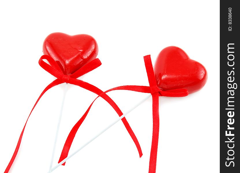 Two Heart Shaped Candies With Bowed Tapes