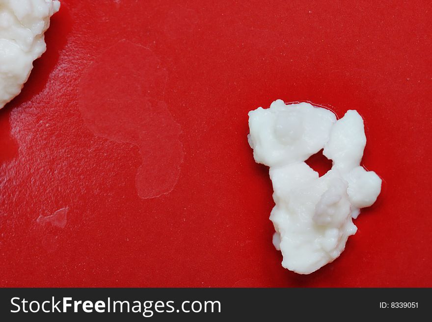 Cottage cheese on the red plate. Close-up. Narrow depth of field. Cottage cheese on the red plate. Close-up. Narrow depth of field.